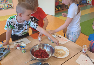 Dzieci uczestniczą w zabawach kulinarnych.