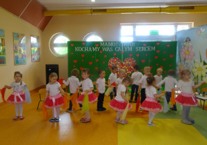 Dzieci trzymają chusteczki tańczą