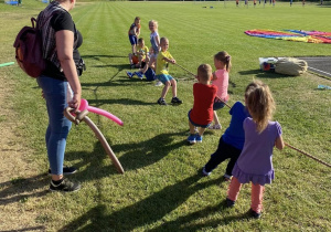dzieci podzielone na dwie drużyny przeciągają linę