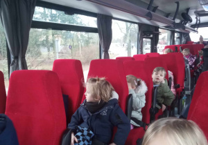Dzieci siedzą w autobusie.